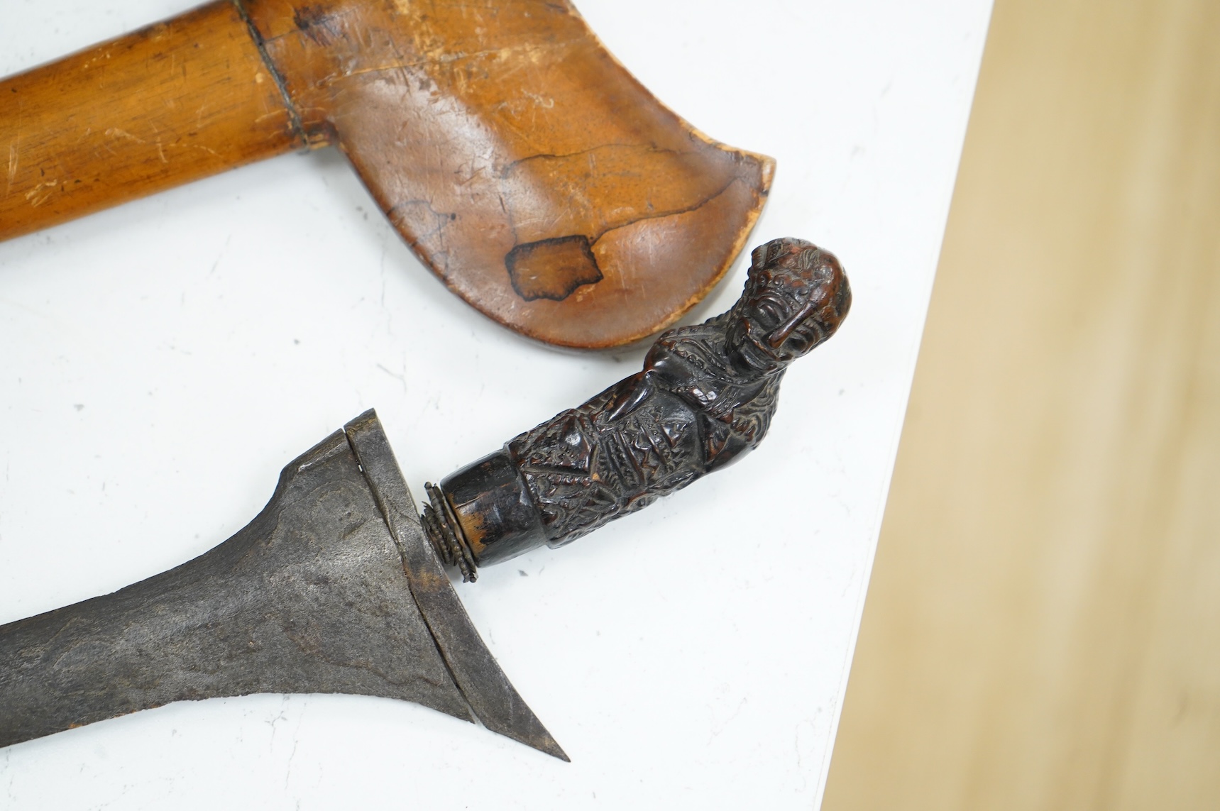A Javanese dagger kris with straight pamor blade, wooden hilt carved as raksha, in its wooden sheath, together with a decorative dagger bade-bade, with etched blade